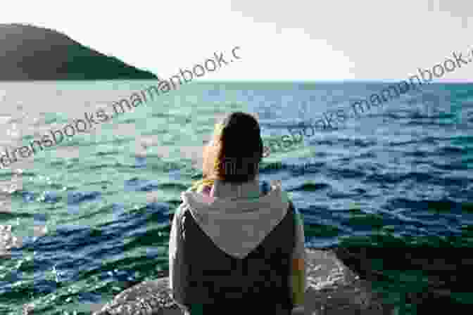 A Young Woman Sitting On A Rock, Gazing Out At A Lake, Lost In Thought Growing Up In Southeastern Oklahoma